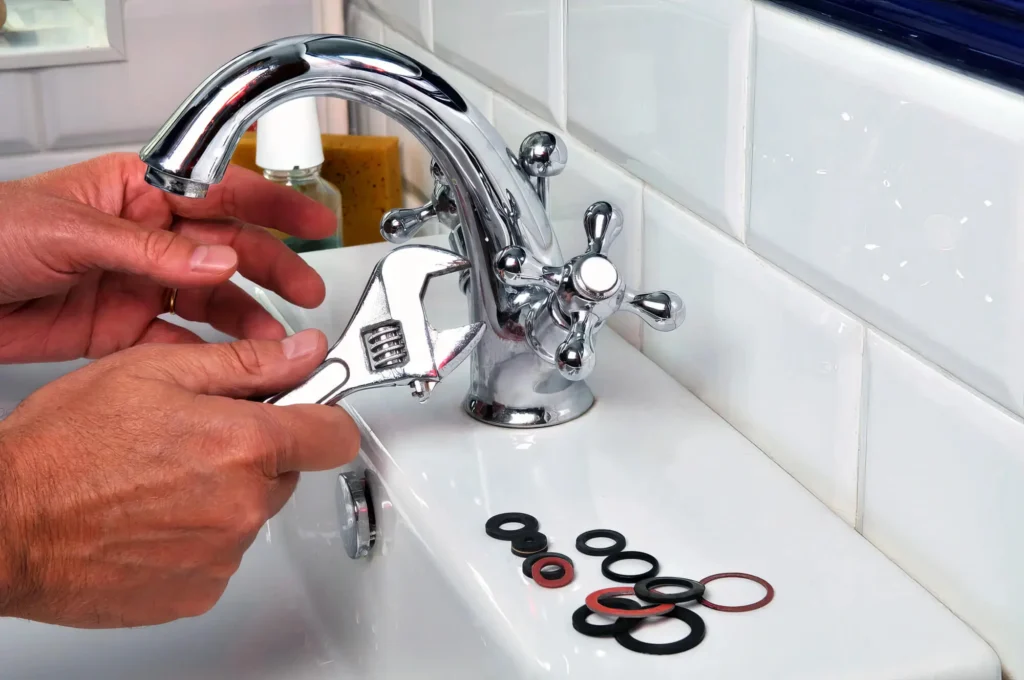 Plumber performing maintenance on a bathroom faucet in Lansdale