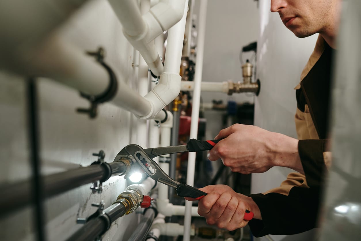 Plumbers maintaining commercial plumbing pipes in Lansdale
