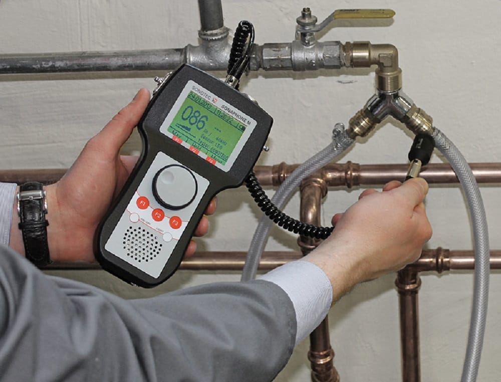 Plumber testing pipes with electronic leak detection equipment in Lansdale