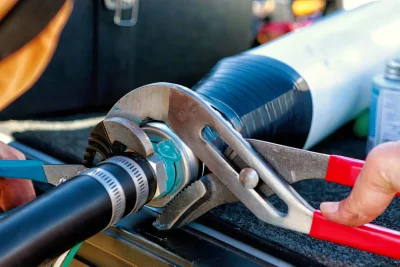 Technician tightening an industrial pipe connection in Lansdale